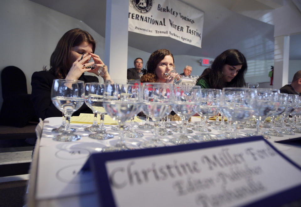 This Feb. 26, 2011 file photo, water Judge Christine Miller Ford, with Panhandle Magazine, samples municipal water during the 21st Berkeley Springs International Water Tasting at The Country Inn in Berkeley Springs, W.Va., The supplier for the state capital of Charleston hasn’t entered the Berkeley Springs International Water Tasting competition since 2010, though the region’s major municipal supplier, West Virginia American Water, won in 1991 and 1994. This year, the water supply has gotten only negative attention: a coal-cleaning agent spilled into the river feeding the water treatment plant for 300,000 people across nine counties, turning water from the taps a shade of blue-green and giving it a sweet, licorice odor. (AP Photo/The Journal Newspaper, Chris Jackson)