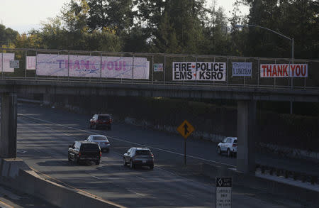 Thank you banners to responders are hung above Highway 101 after wildfires tore through portions of Santa Rosa, California, U.S., October 15, 2017. REUTERS/Jim Urquhart