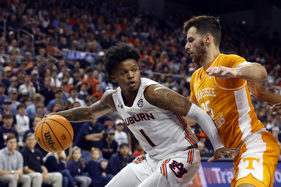 Auburn guard Wendell Green Jr. (1) dribbles as Tennessee guard Santiago Vescovi (25) blocks out during the second half of an NCAA college basketball game Saturday, March 4, 2023, in Auburn, Ala. (AP Photo/Butch Dill)