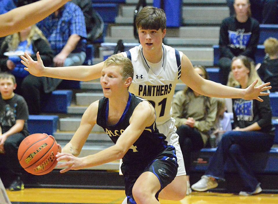 Florence-Henry's Peyton Roe dishes the ball while being guarded by Great Plains Lutheran's Austin Rubendall during a high school basketball doubleheader on Thursday, Jan. 26, 2023 in Watertown.