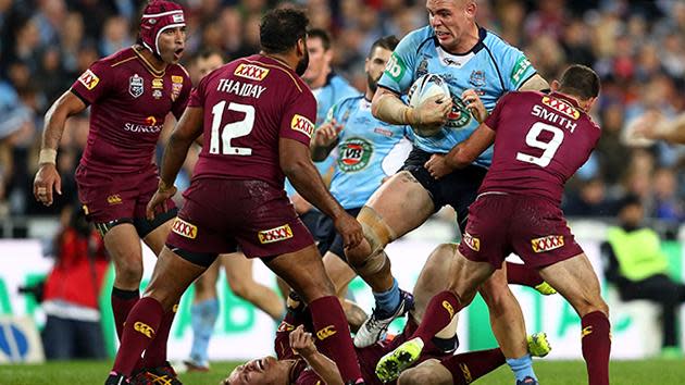 Blues prop David Klemmer poleaxes Michael Morgan of the Maroons.