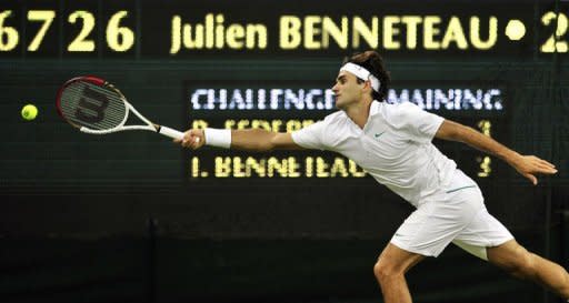 Switzerland's Roger Federer streches to reach the ball during his third round men's singles match against France's Julien Benneteau at Wimbledon. Federer won 4-6, 6-7 (3/7), 6-2, 7-6 (8/6), 6-1