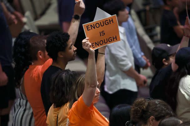 PHOTO: People hold signs reading ' Enough is Enough' as they attend a vigil, May 7, 2023 in Allen, Texas. (Joe Raedle/Getty Images)