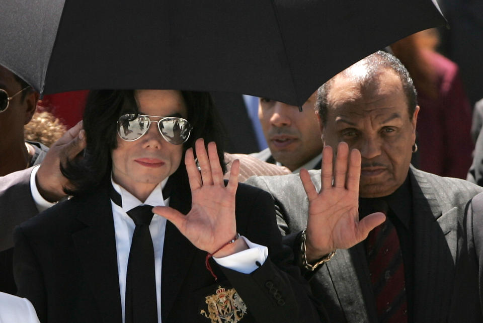 Michael Jackson, left, and his father, Joe Jackson, wave to fans in Santa Maria, Calif., in 2005. (Photo: Win McNamee/Getty Images)