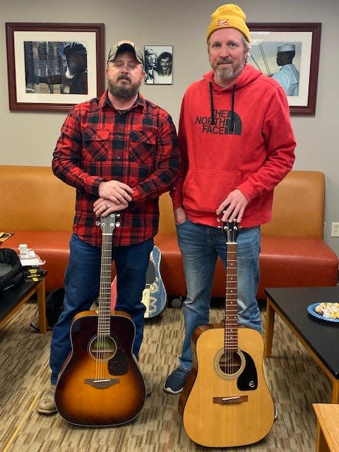 Ben Newcomer poses with instructor Jeremy Linton in the Guitar for Vets program at the South Bend Vet Center.