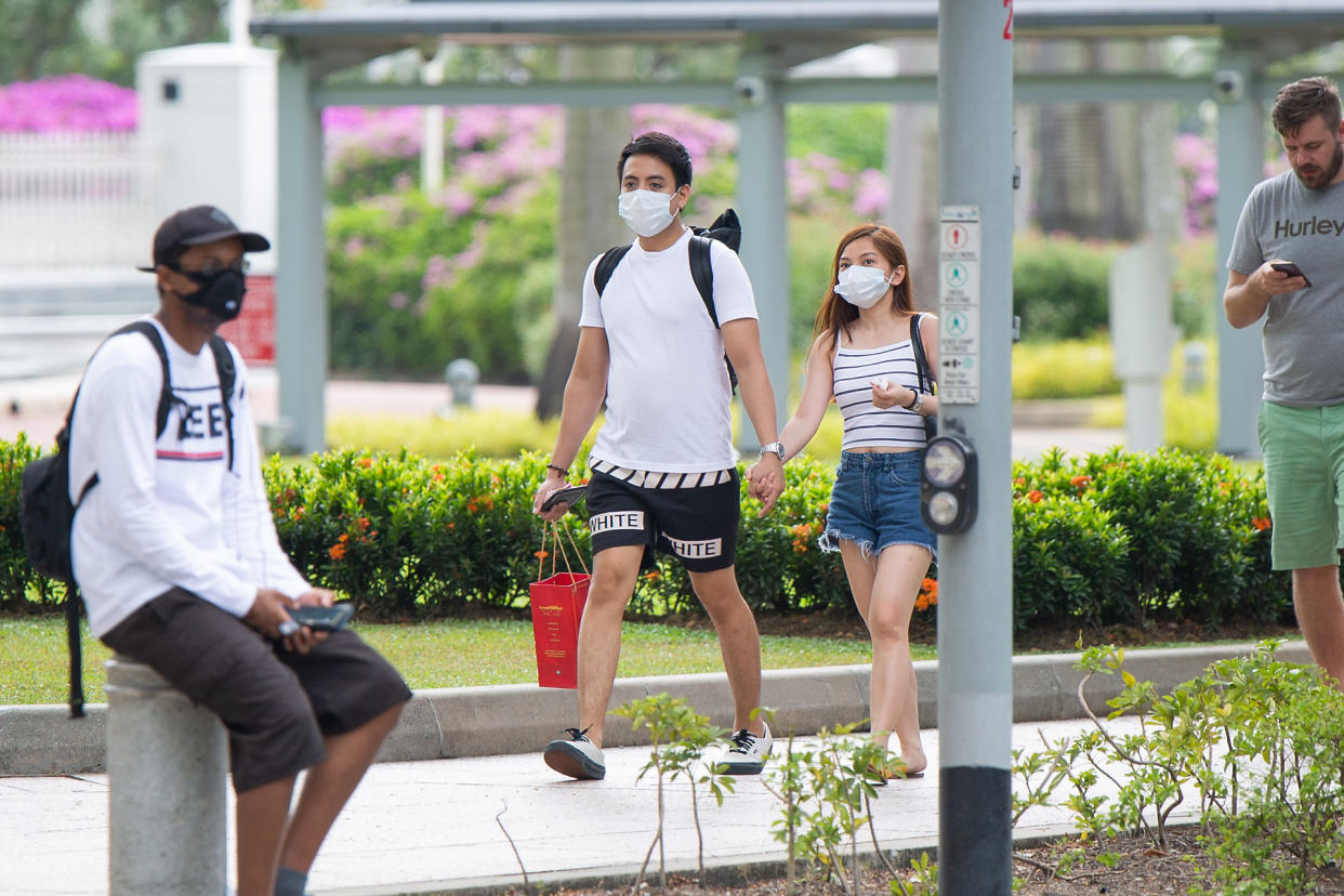 A couple wearing face masks seen walking outside Parliament House on Monday (27 January). (PHOTO: Dhany Osman / Yahoo News Singapore)