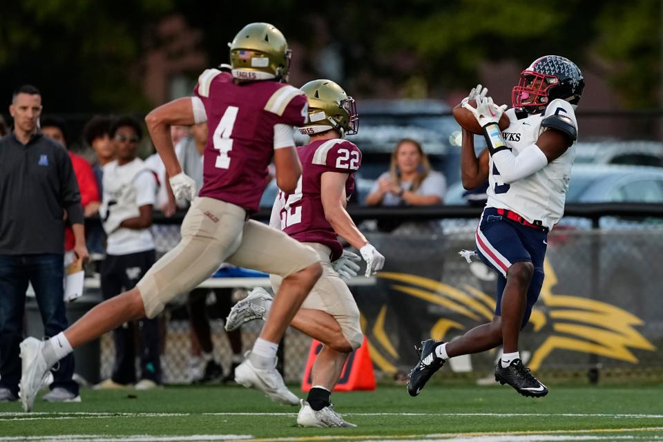 Sep 22, 2023; Columbus, Ohio, USA; Hartley’s Ryan Perry (5) catches a pass in front of Watterson’s TOmmy Haley (22) and Drew Bellisari (4) during the first half of the high school football game at Ohio Dominican University.