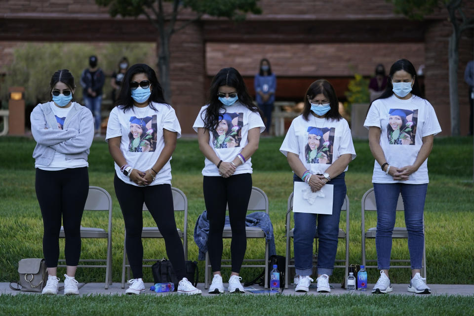 People bow their heads in prayer during a ceremony Thursday, Oct. 1, 2020, on the anniversary of the mass shooting three years earlier in Las Vegas. The ceremony was held for survivors and victim's families of the deadliest mass shooting in modern U.S. history. (AP Photo/John Locher)