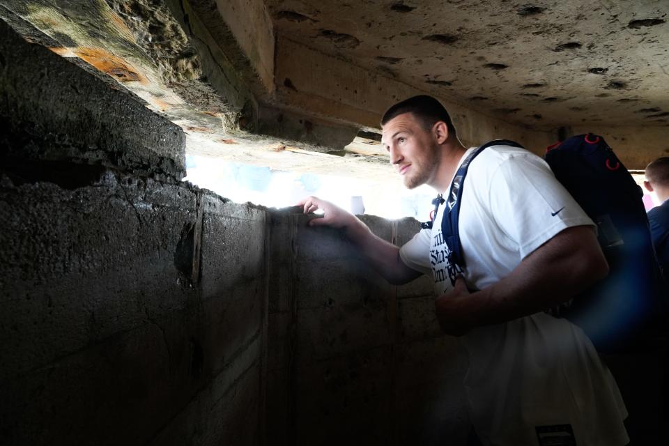 U.S. Olympic wrestler Mason Parris looks out from a bunker at Point du Hoc on the beaches of Normandy. The bluff was home to a German command center on D-Day.