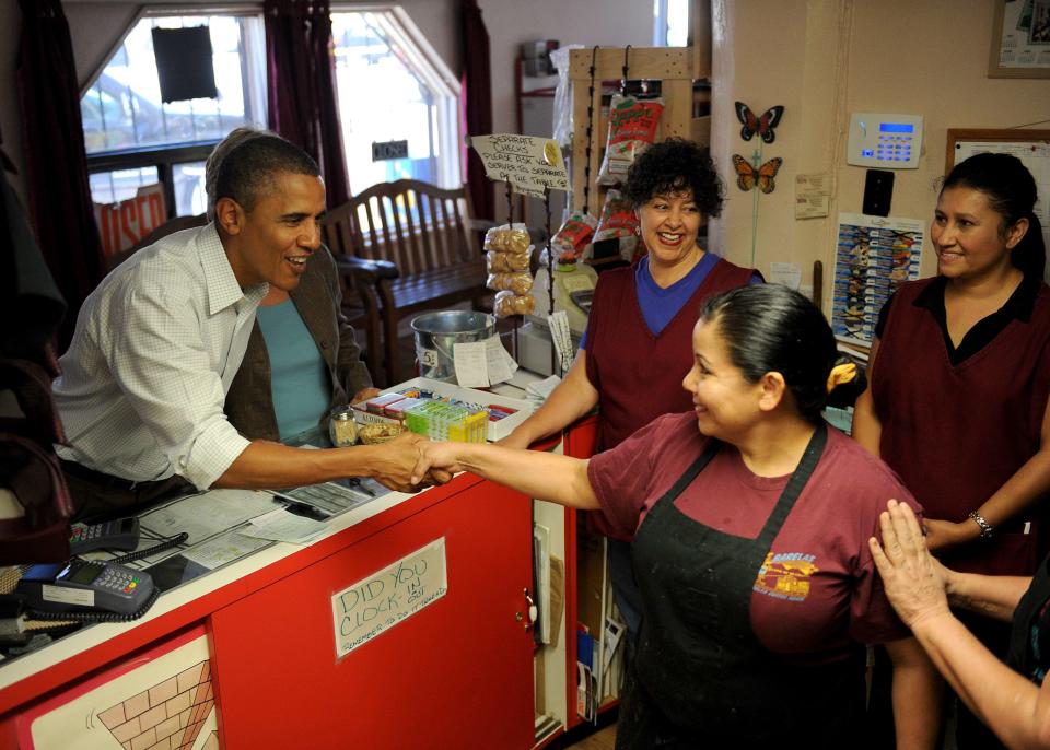 President Barack Obama (left) shakes hands with employees at Barelas Coffee House September 28, 2010, in Albuquerque, New Mexico.