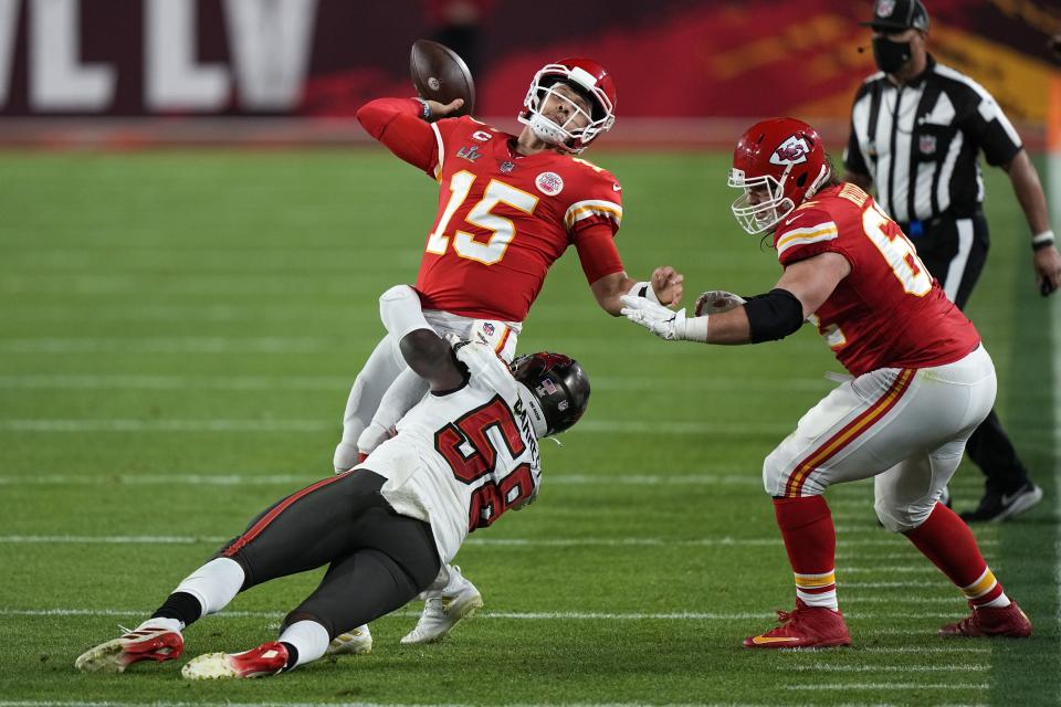 Kansas City Chiefs quarterback Patrick Mahomes passes under pressure from Tampa Bay Buccaneers outside linebacker Shaquil Barrett during the second half of the NFL Super Bowl 55 football game, Sunday, Feb. 7, 2021, in Tampa, Fla. (AP Photo/David J. Phillip)