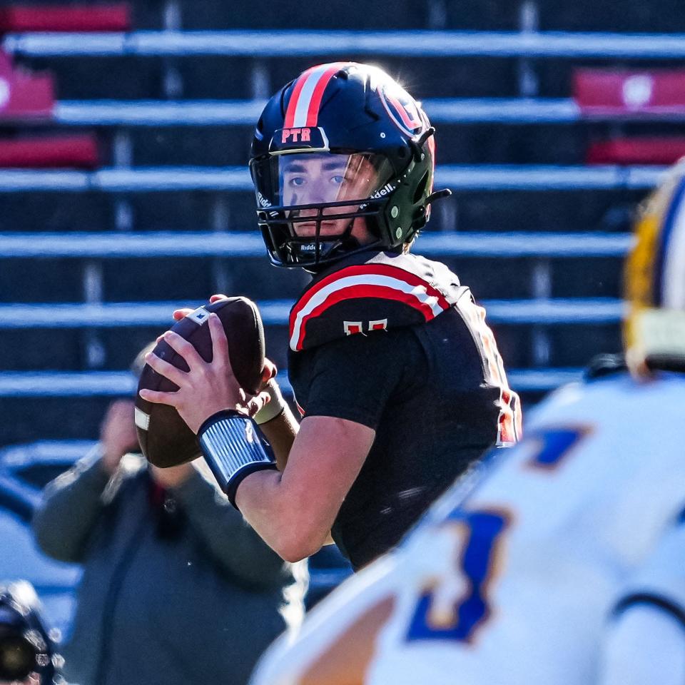 Grafton quarterback Brady Hilgart (11) drops back to pass during the WIAA Division 3 state championship football game against Rice Lake at Camp Randall Stadium in Madison on Friday, November 17, 2023.