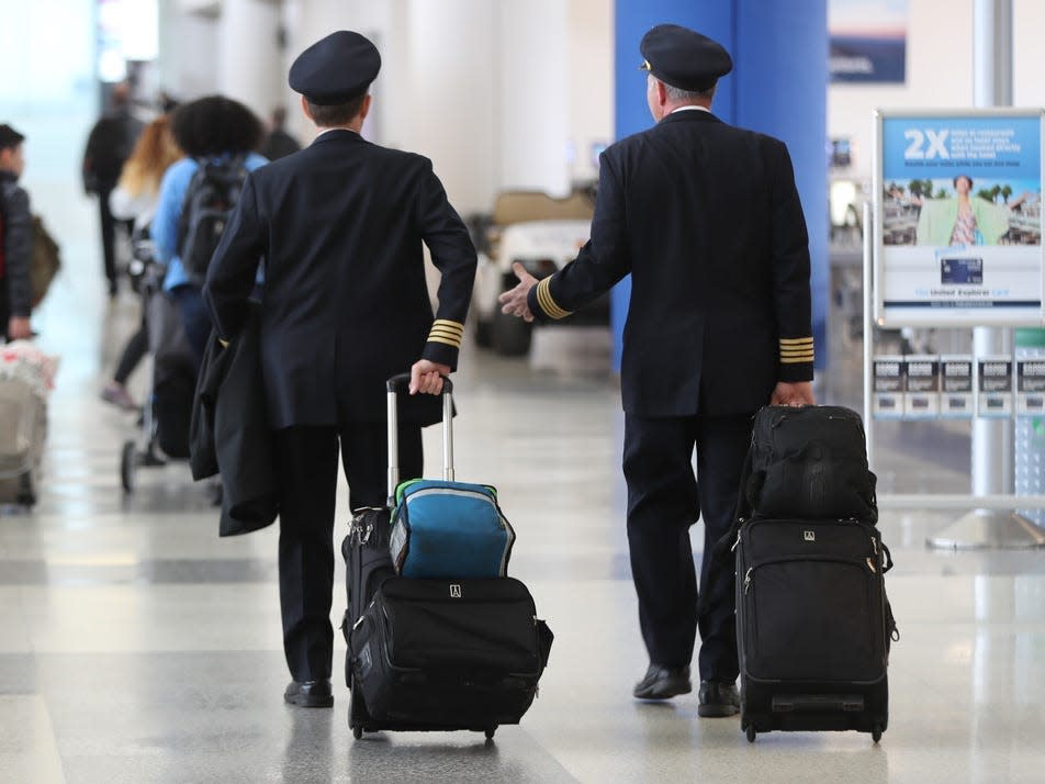 United Airlines pilots walk through Newark Liberty International Airport
