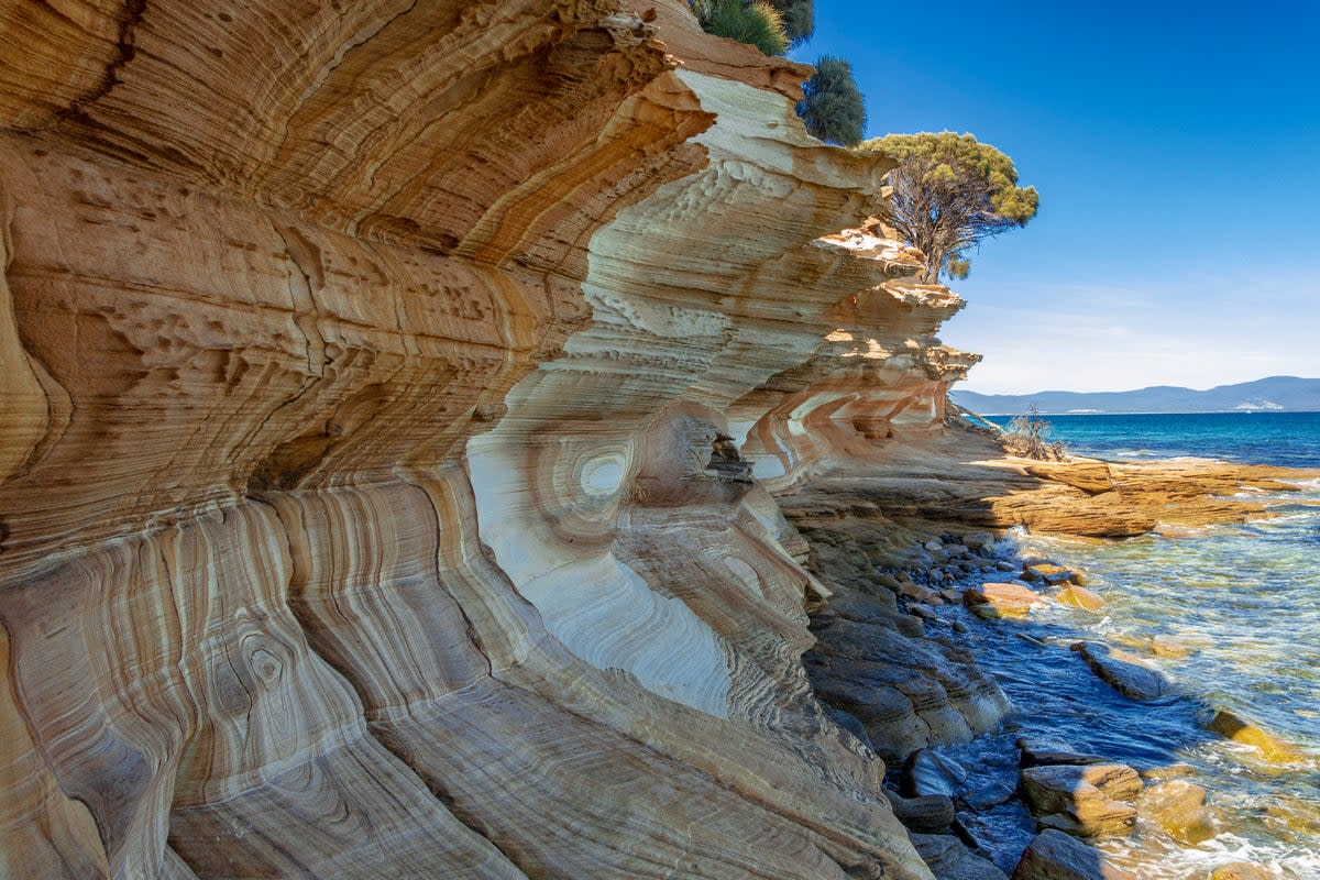 The wonderful ‘painted cliffs’ on Maria Island (Getty Images)