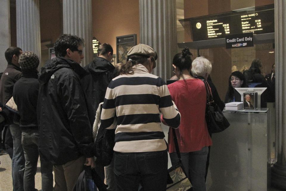 In this Tuesday, March 19, 2013 photo visitors to the Metropolitan Museum of Art in New York wait in line to buy admission tickets. (AP Photo/Mary Altaffer)