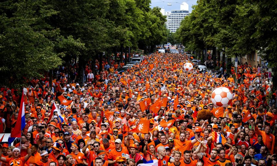 <span>Dutch fans walk behind the Oranjebus in Munich. Bit of a squeeze.</span><span>Photograph: Hollandse Hoogte/Shutterstock</span>