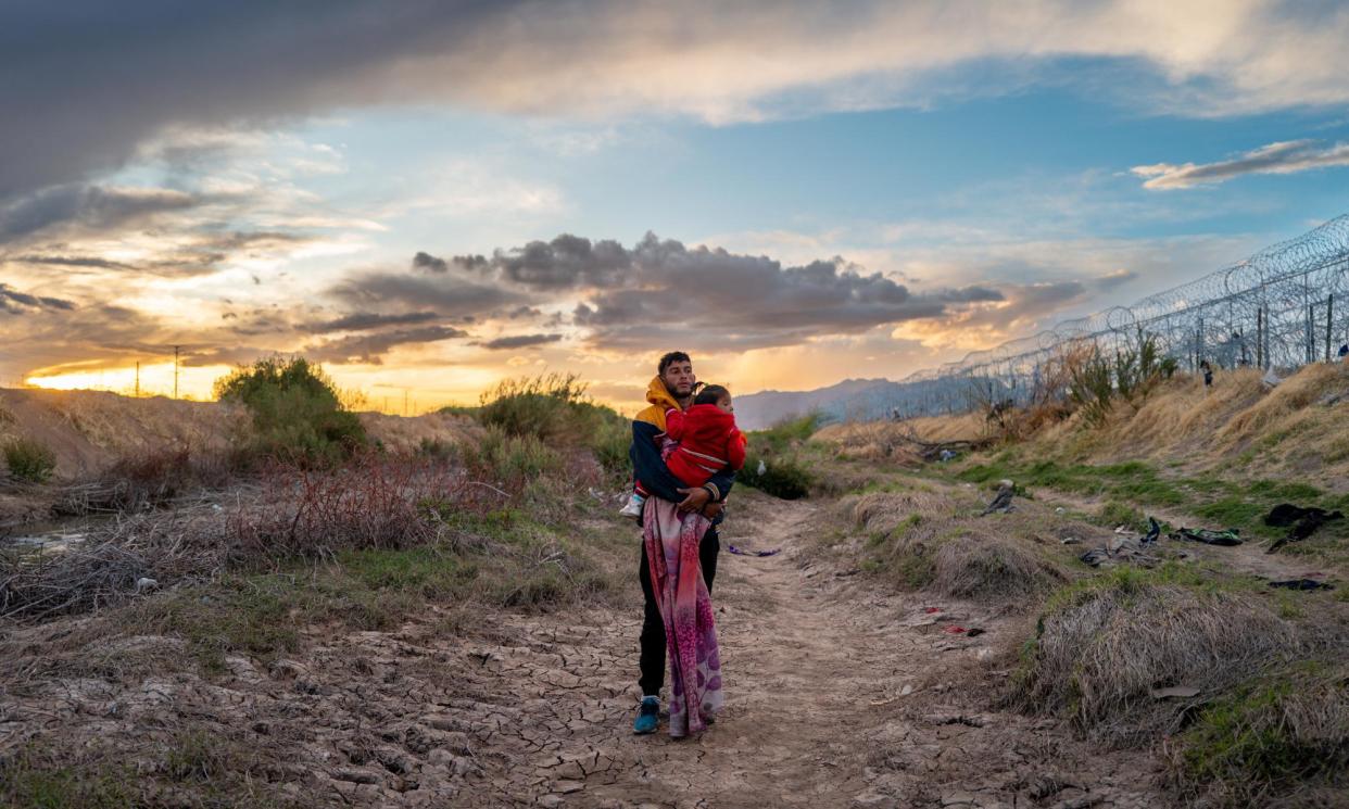<span>Peruvian migrants at the US-Mexico border.</span><span>Photograph: Brandon Bell/Getty Images</span>
