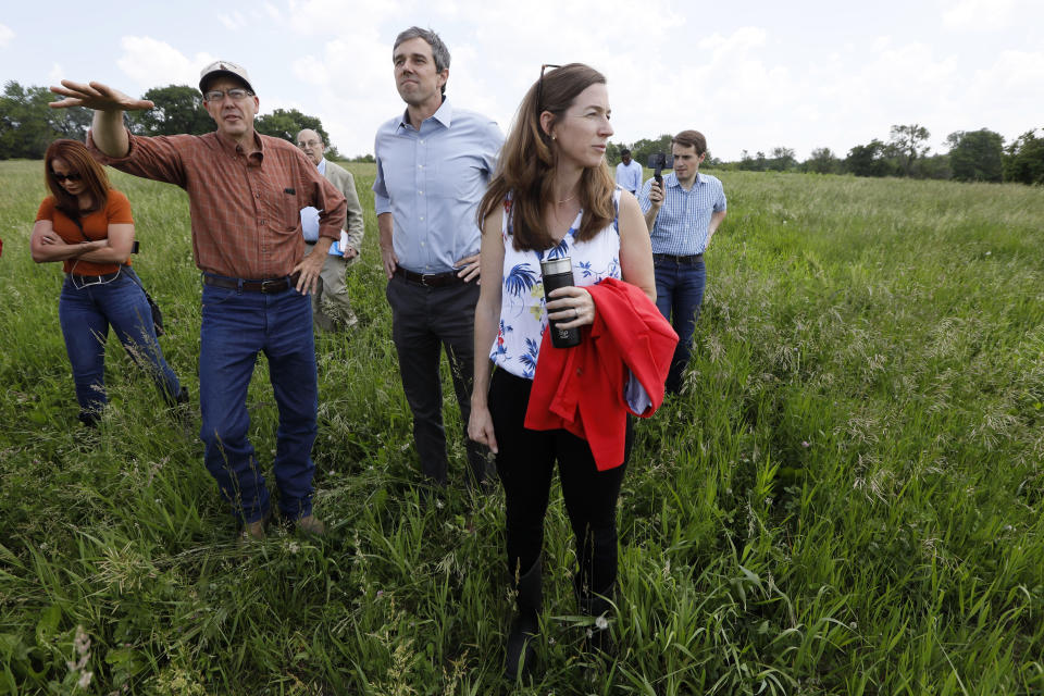 Democratic presidential candidate Beto O'Rourke, center, and his wife Amy, right, talk with Matt Russell, left, while touring his Coyote Run Farm, Friday, June 7, 2019, in Lacona, Iowa. (AP Photo/Charlie Neibergall)