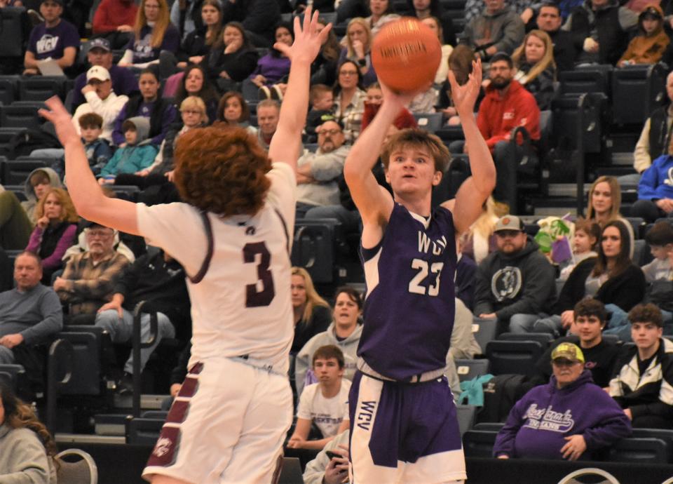 West Canada Valley Indian Camerohn Ludwig (right) attempts a three-point shot during the fourth quarter of a Section III semifinal Saturday, Feb. 25, 2023, at SRC Arena on the Syracuse, New York, campus of Onondaga Community College.