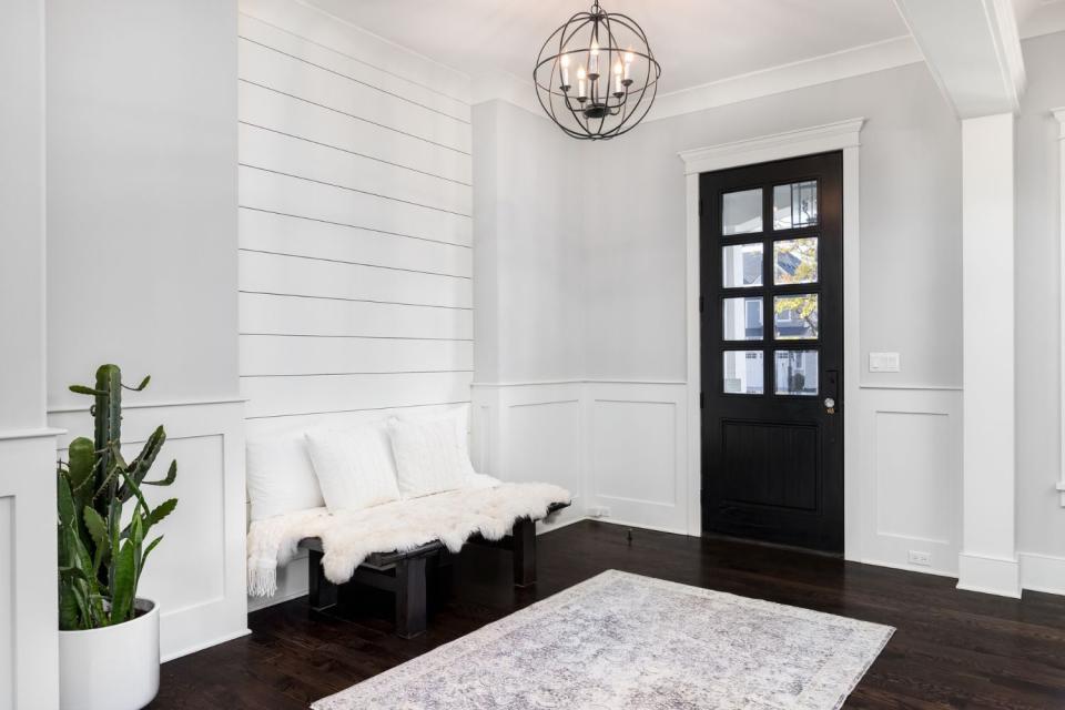 An example of white shiplap installed in a foyer.