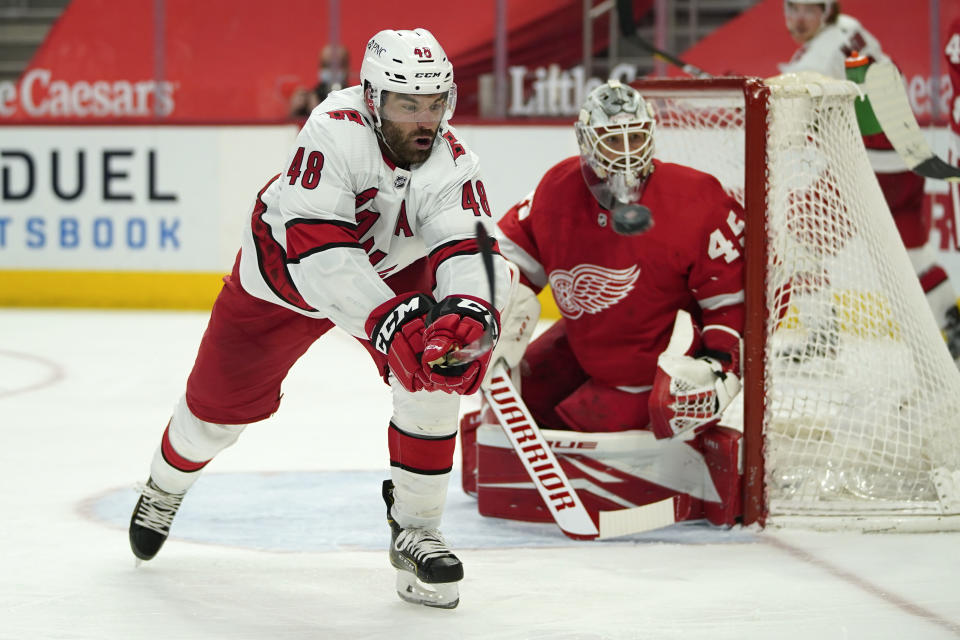 Carolina Hurricanes left wing Jordan Martinook (48) tries to knock down the puck on a pass against the Detroit Red Wings in the third period of an NHL hockey game Sunday, March 14, 2021, in Detroit. (AP Photo/Paul Sancya)