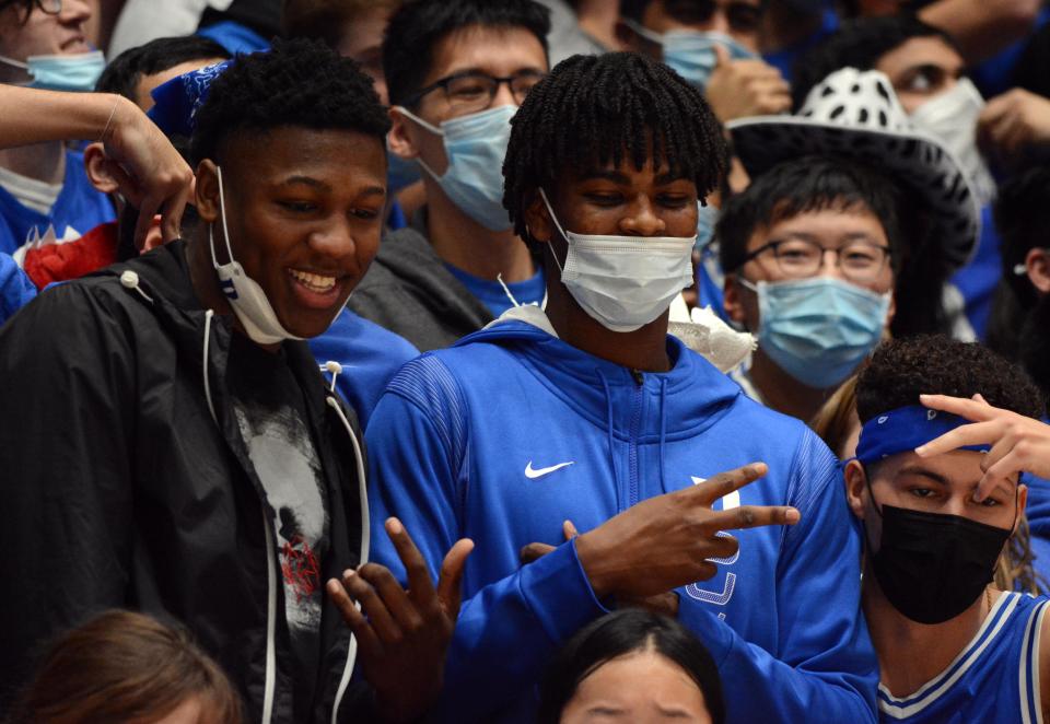 G.G. Jackson, a five-star 2023 Duke basketball recruiting target (left), and Sean Stewart, a four-star 2023 Duke basketball verbal commit (right), pose for pictures among the Cameron Crazies during the second half of a Jan. 22, 2022, home win against Syracuse. Jackson, who's also receiving heavy attention from UNC, was on an official visit to Duke the weekend of Jan. 21.