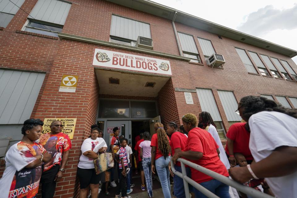 Family and friends enter South Delta Middle School, for graduation ceremonies in Anguilla, Miss., Friday, May 19, 2023. Many students living in nearby Rolling Fork had their homes destroyed in a recent tornado. (AP Photo/Gerald Herbert)