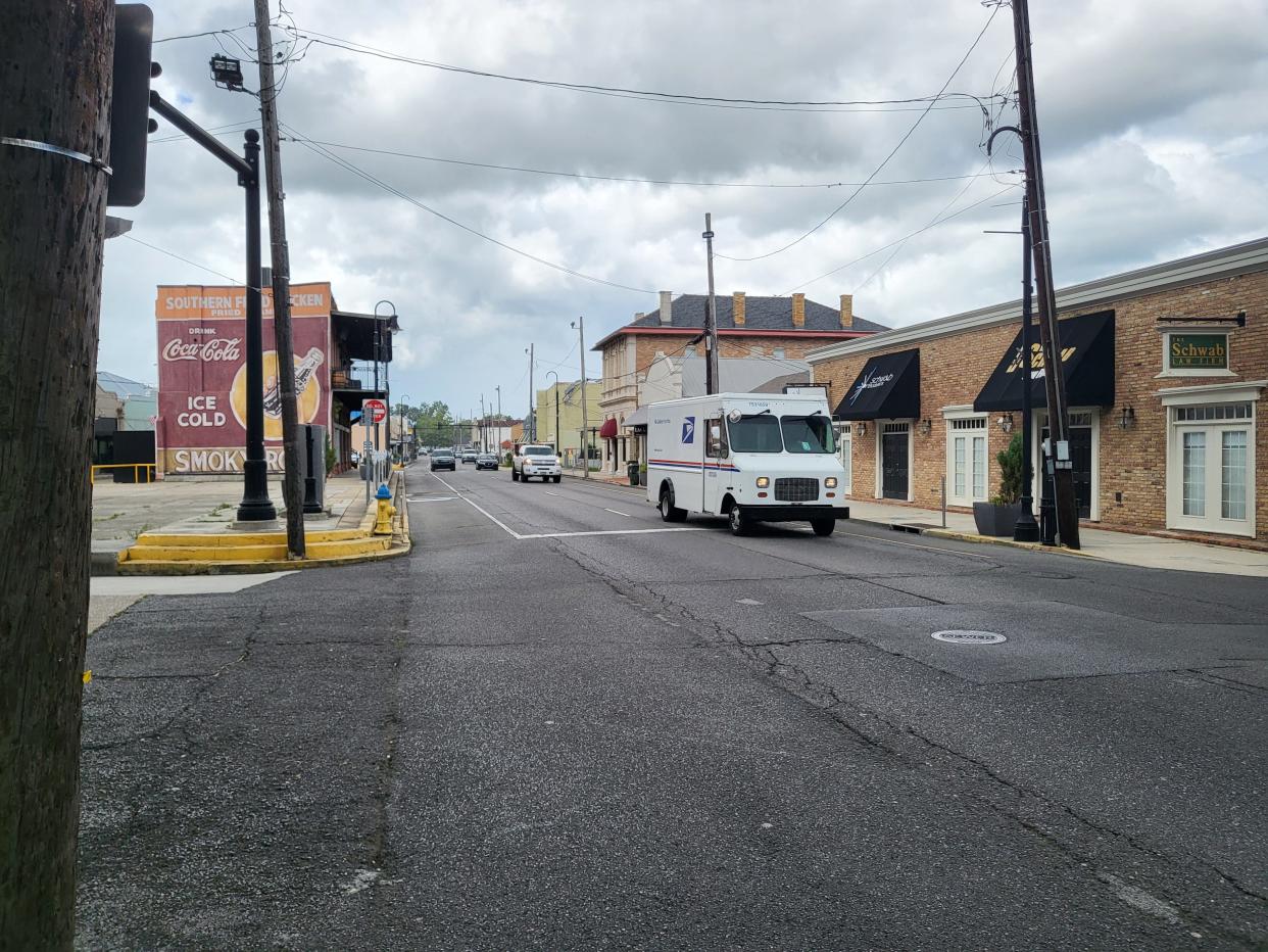 Vehicles head down Main Street in downtown Houma Friday afternoon, July 8, 2022.