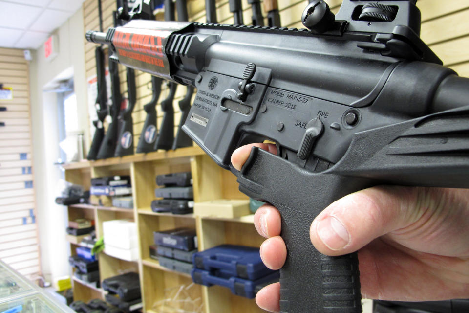 FILE - An employee of North Raleigh Guns demonstrates how a bump stock works at the Raleigh, N.C., on Feb. 1, 2013. Gun accessories known as bump stocks hit the market more than a decade ago. The U.S. government initially concluded that the devices that make semi-automatic weapons fire faster didn't violate a federal ban on machine guns. That changed after a gunman with bump stock-equipped rifles killed 60 people and wounded hundreds in Las Vegas in 2017. (AP Photo/Allen Breed, File)