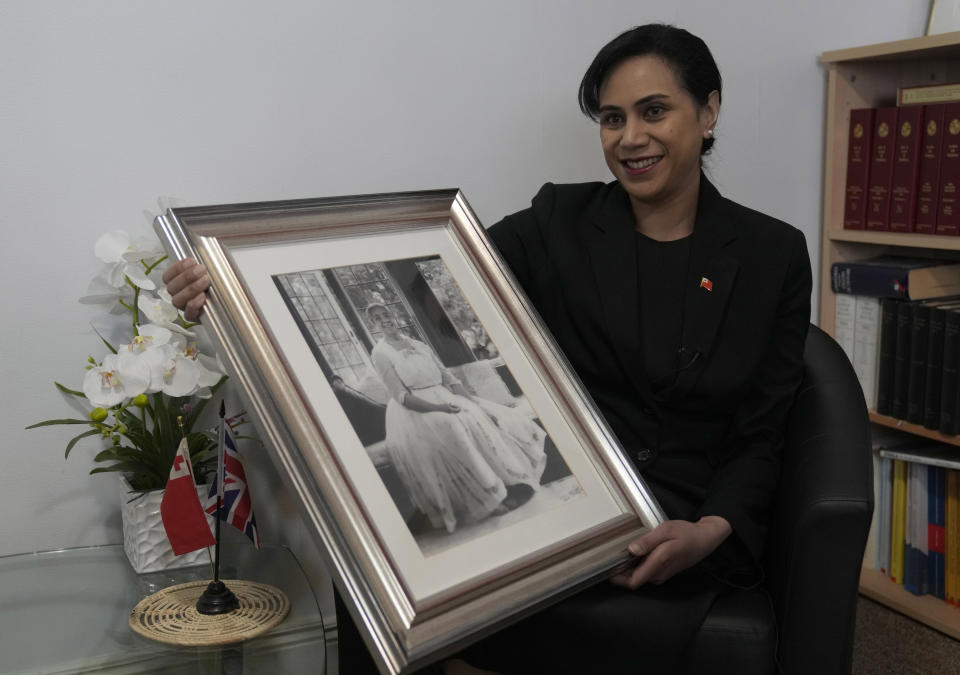 Tonga High Commissioner to the UK, Titilupe Fanetupouvava'u Tu'ivakano holds a portrait of her great grandmother Queen Salote Tupou III, during an interview with the Associated Press at the High Commission in London, Monday, May 30, 2022. As well as celebrating Queen Elizabeth II’s Platinum Jubilee, Tu’ivakano will also remember her great- grandmother Queen Salote Tupou III, who endeared herself to Britons as she rode through the streets of London in an open carriage during Elizabeth’s coronation parade in 1953. (AP Photo/Alastair Grant)