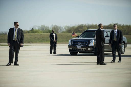 Members of the Secret Service await the arrival of US President Barack Obama at Detroit Metro Wayne County Airport in Detroit, Michigan. The US Secret Service said Wednesday that three employees will leave their jobs over the sex scandal in a hotel in Colombia which tarnished the elite presidential protection agency's image