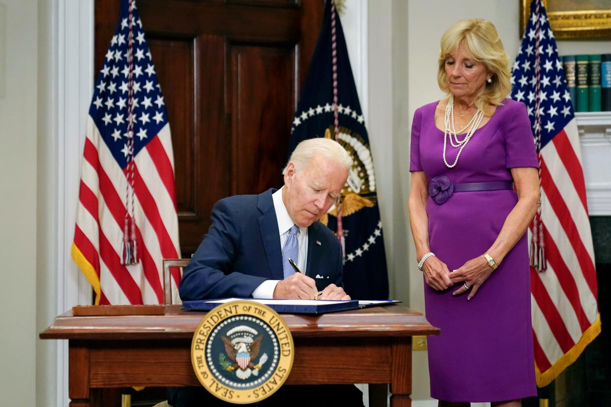 President Joe Biden signs into law S. 2938, the Bipartisan Safer Communities Act gun safety bill, in the Roosevelt Room of the White House as first lady Jill Biden looks on, on June 25, 2022.