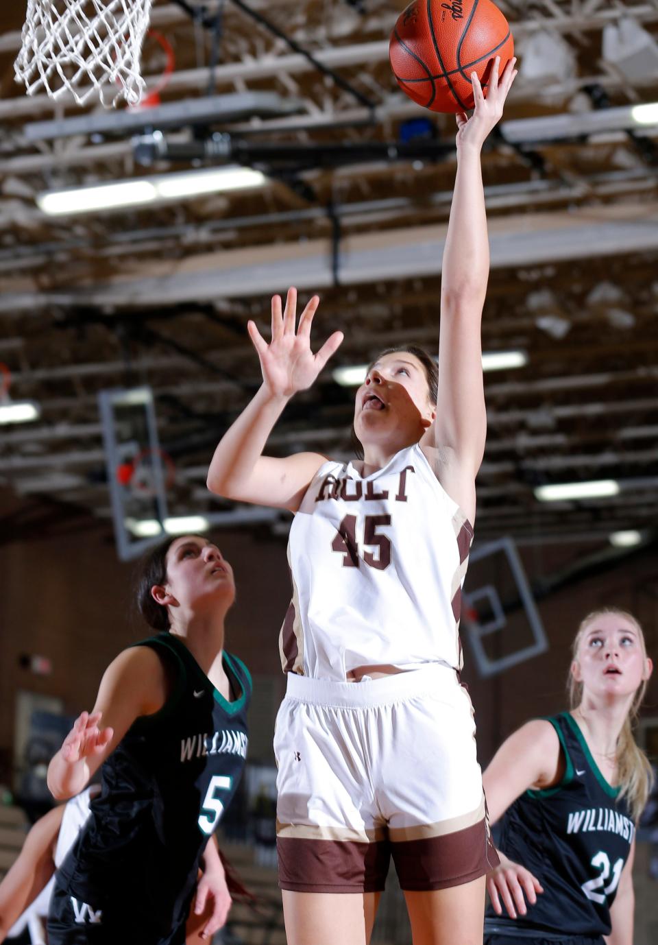 Holt's Kaylin Howard (45) shoots over Williamston's Reese Gaytan, left, and Grace Porrell, Tuesday, Jan. 25, 2022, in Holt. Holt won 65-52.