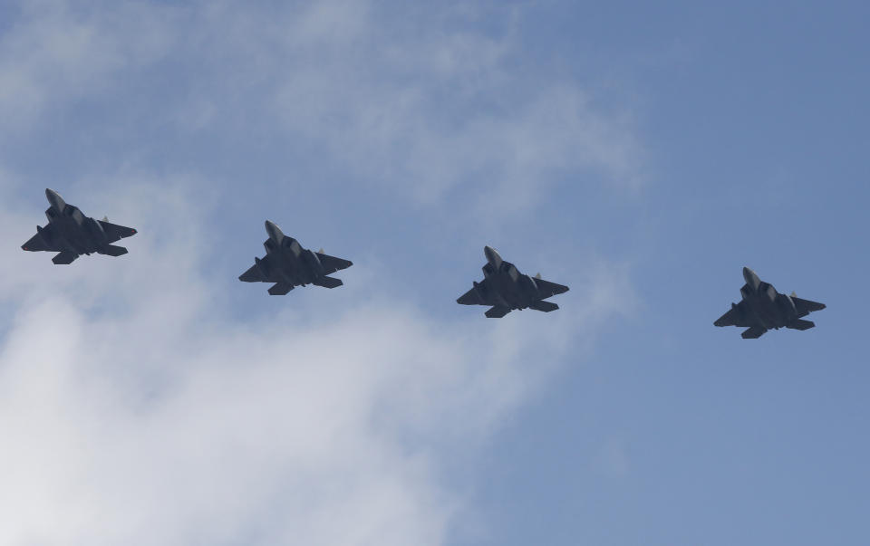 FILE - Four U.S. F-22 stealth fighters fly over Osan Air Base in Pyeongtaek, South Korea, on Feb. 17, 2016. The United States flew nuclear-capable bombers and advanced stealth jets near the Korean Peninsula for joint drills with South Korean warplanes on Tuesday, Dec. 20, 2022 as the powerful sister of North Korean leader Kim Jong Un derided doubts about her country's military and threatened a full-range intercontinental ballistic missile test. (AP Photo/Lee Jin-man, File)