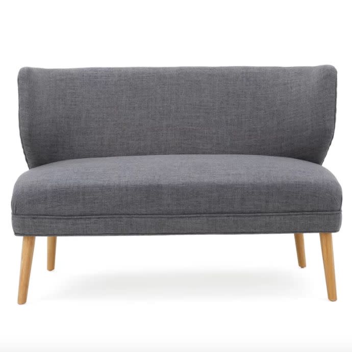 For under $200, this <a href="https://www.wayfair.com/furniture/pdp/langley-street-raleigh-fabric-settee-lgly3902.html?piid=19309480" target="_blank">couch</a> provides extra comfort and goes great with additional furniture without taking up too much space.