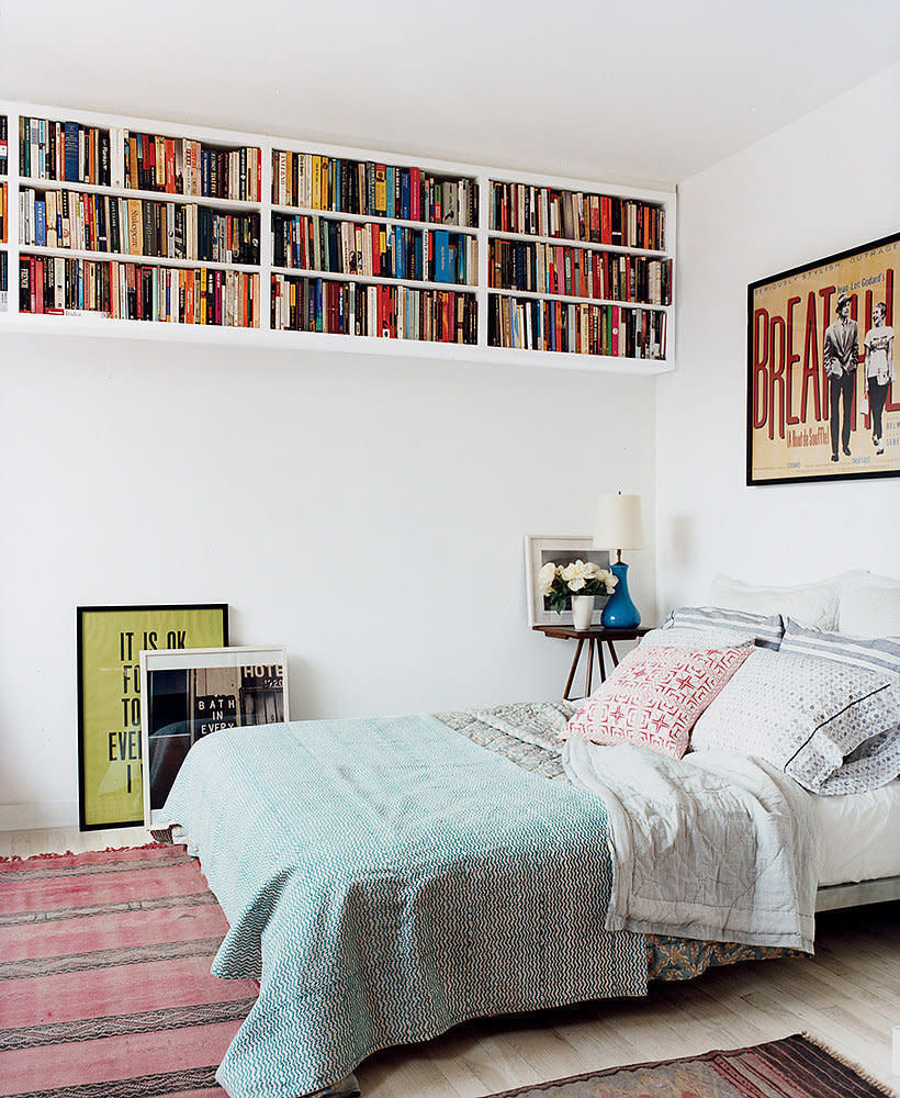 Display your books up high. Shelves lined around the very top of a room can help give the space height - and keep the walls clear. [Photo: Pinterest]