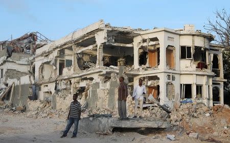Somali businessmen stand near the scene of last Saturday explosion in KM4 street in the Hodan district in Mogadishu, Somalia October 17, 2017. REUTERS/Feisal Omar