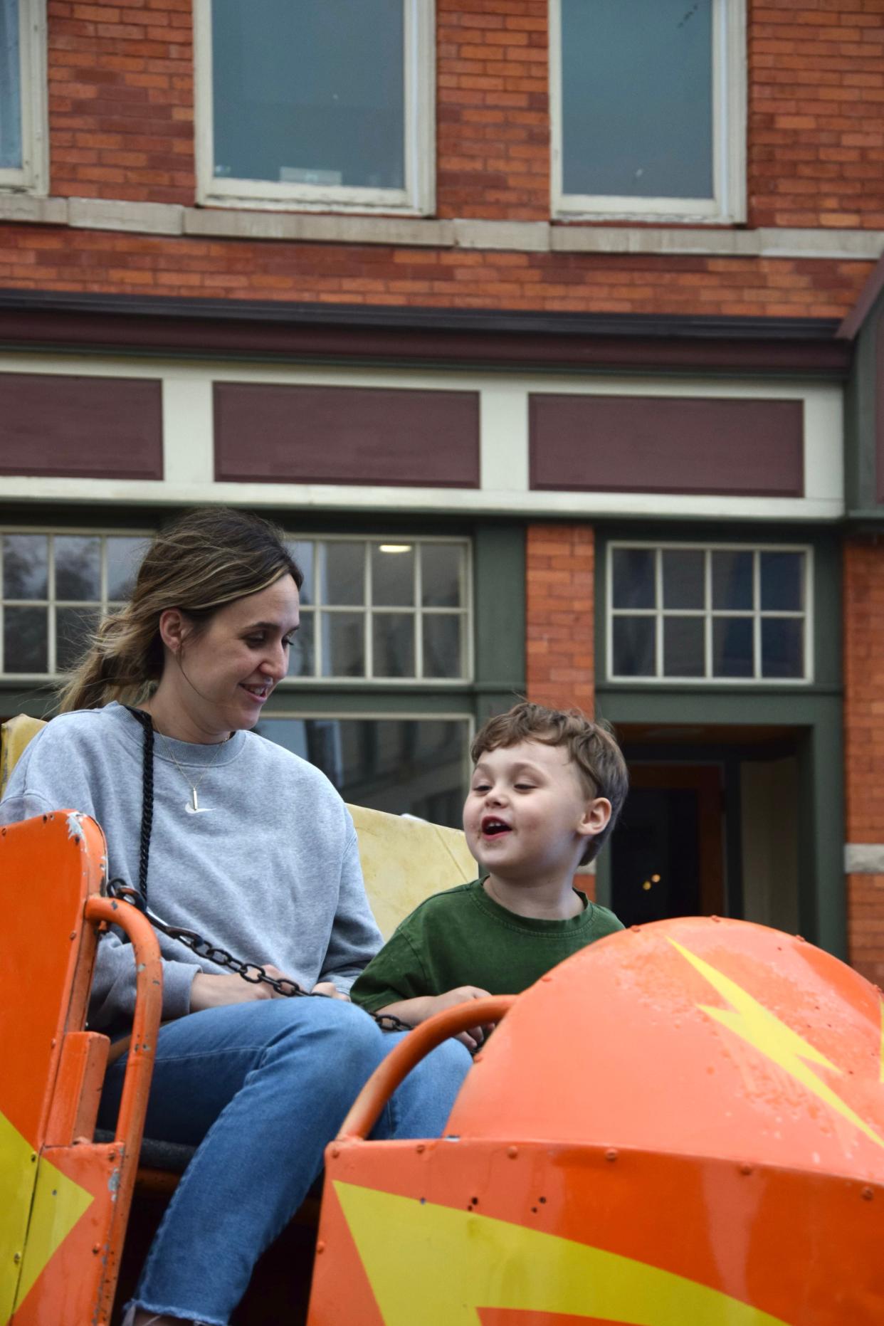 Kelsey and Hoyt Smith, 3, ride a ride at the East Jordan Freedom Festival on Friday, June 21, 2024.