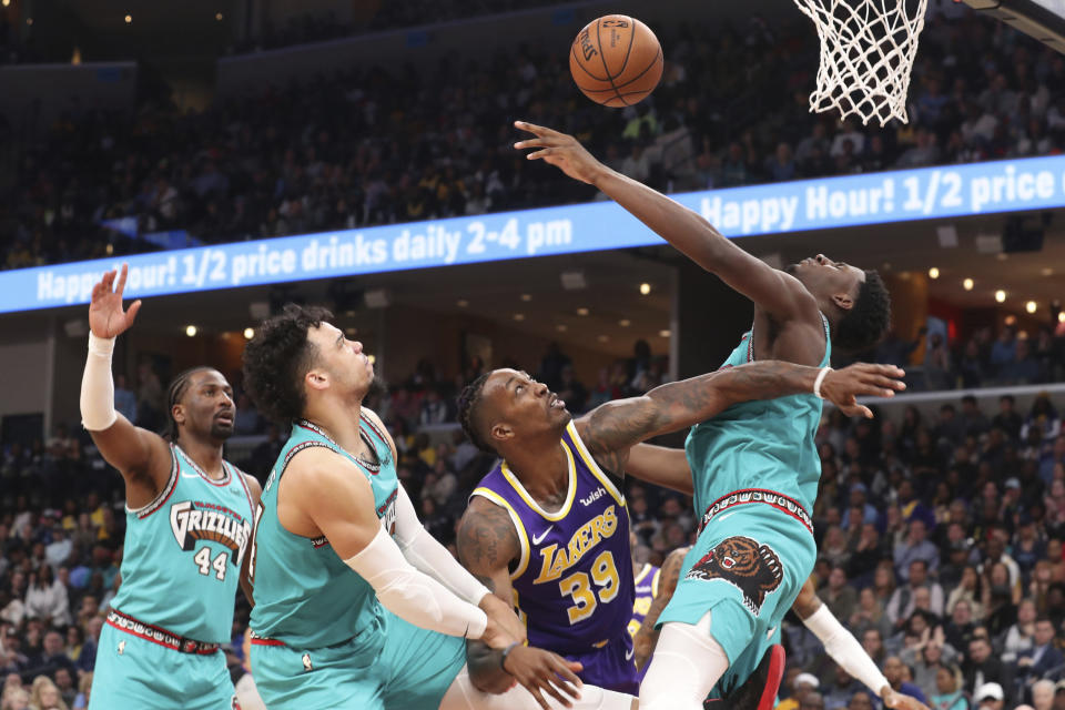 Memphis Grizzlies' Dillon Brooks (24), Jaren Jackson Jr. (13) and Los Angeles Lakers' Dwight Howard (39) go after a loose ball in the second half of an NBA basketball game Saturday, Nov. 23, 2019, in Memphis, Tenn. (AP Photo/Karen Pulfer Focht)