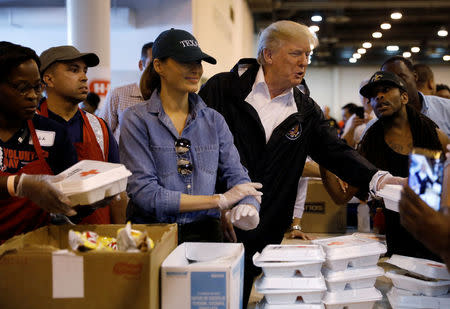 U.S. President Donald Trump and first lady Melania Trump help volunteers hand out meals during a visit with flood survivors of Hurricane Harvey at a relief center in Houston, Texas, U.S., September 2, 2017. REUTERS/Kevin Lamarque
