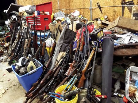 Stacks of guns are seen in a garage belonging to Brent Nicholson in Pageland, South Carolina, in this undated handout picture provided by the Chesterfield County (SC) Sheriff's Office. Inside Brent Nicholson's house, guns were everywhere: rifles and shotguns piled in the living room, halls and bedrooms; handguns littering tables and countertops. Outside, when sheriff's investigators rolled up the door on the pre-fab metal garage, more arms spilled out at their feet. The question of how one man amassed such a stockpile of guns arises just as there is renewed American soul-searching over the widespread availability of firearms in the wake of a series of mass shootings. REUTERS/Chesterfield County (SC) Sheriff's Office/Handout via Reuters