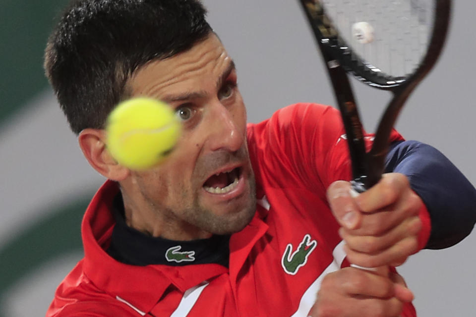 Serbia's Novak Djokovic plays a shot against Russia's Karen Khachanov in the fourth round match of the French Open tennis tournament at the Roland Garros stadium in Paris, France, Monday, Oct. 5, 2020. (AP Photo/Michel Euler)