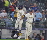 Milwaukee Brewers' Jackson Chourio, left, reacts after hitting a home run during the fifth inning of a baseball game against the Minnesota Twins Wednesday, April 3, 2024, in Milwaukee. It was his first major league home run. (AP Photo/Jeffrey Phelps)