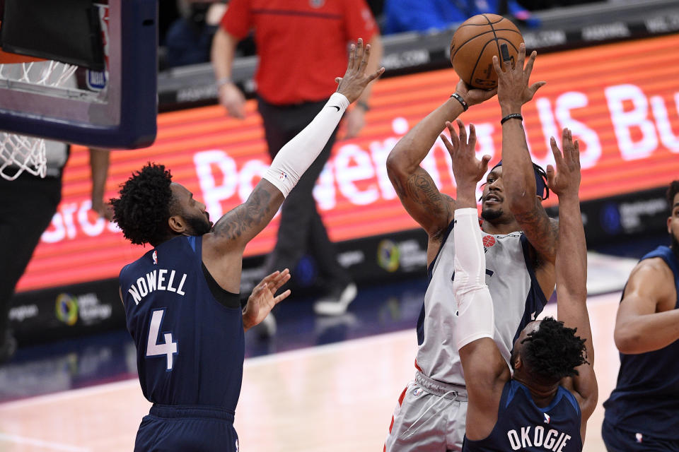 Washington Wizards guard Bradley Beal, top right, shoots under pressure from Minnesota Timberwolves guard Jaylen Nowell (4) and forward Josh Okogie, bottom right, during the first half of an NBA basketball game, Saturday, Feb. 27, 2021, in Washington. (AP Photo/Nick Wass)