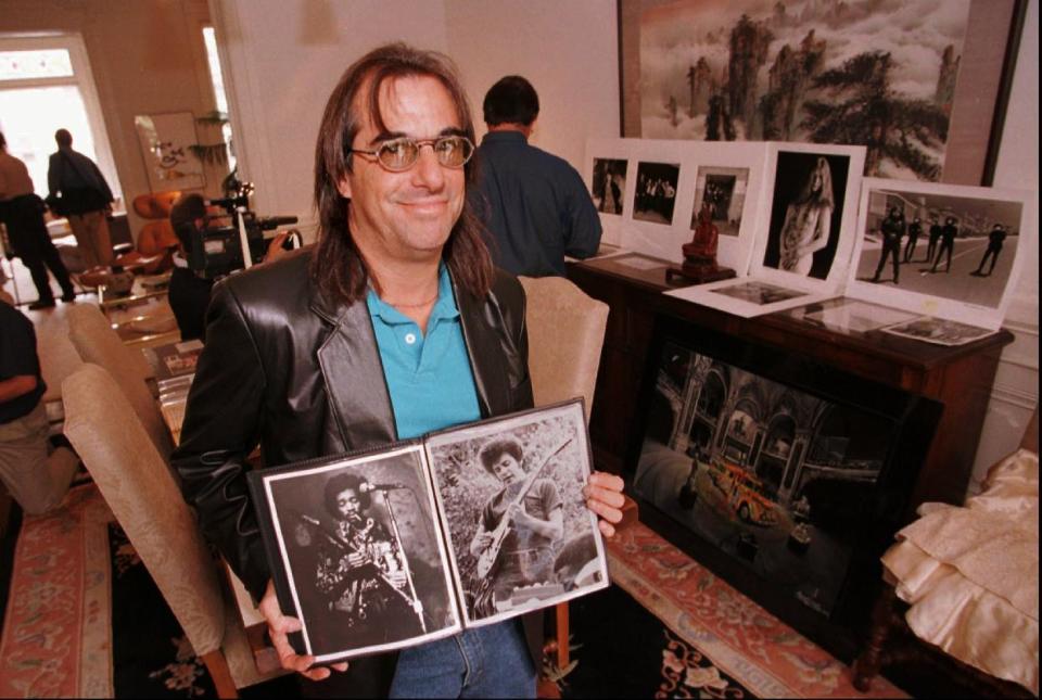 FILE - In this Aug. 18, 1997, file photo, Sixties era rock photographer Grant Jacobs holds images he shot of sixties rock stars in San Francisco. Jacobs is inside the former residence of the rock band "The Grateful Dead" in the Haight-Ashbury district of San Francisco. City officials have rejected a permit for a planned free concert intended to mark the 50th anniversary of the famed Summer of Love in Golden Gate Park that had been planned for June 2017. (AP Photo/Dwayne Newton)