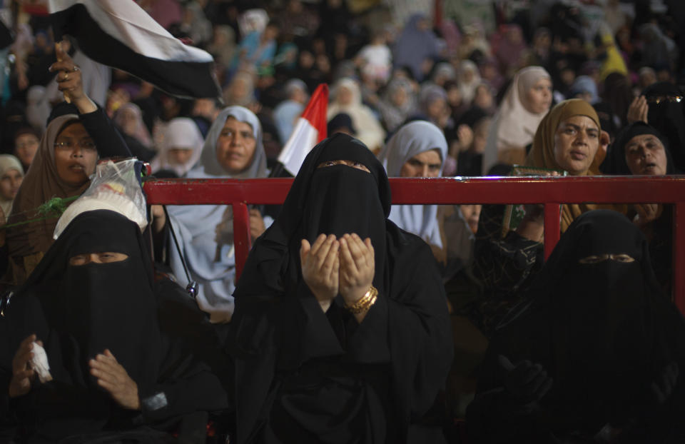 Supporters of Egypt's ousted President Mohammed Morsi pray outside Rabaah al-Adawiya mosque, where protesters have installed a camp and hold daily rallies at Nasr City in Cairo, Egypt, Thursday, Aug. 1, 2013. (AP Photo/Khalil Hamra)