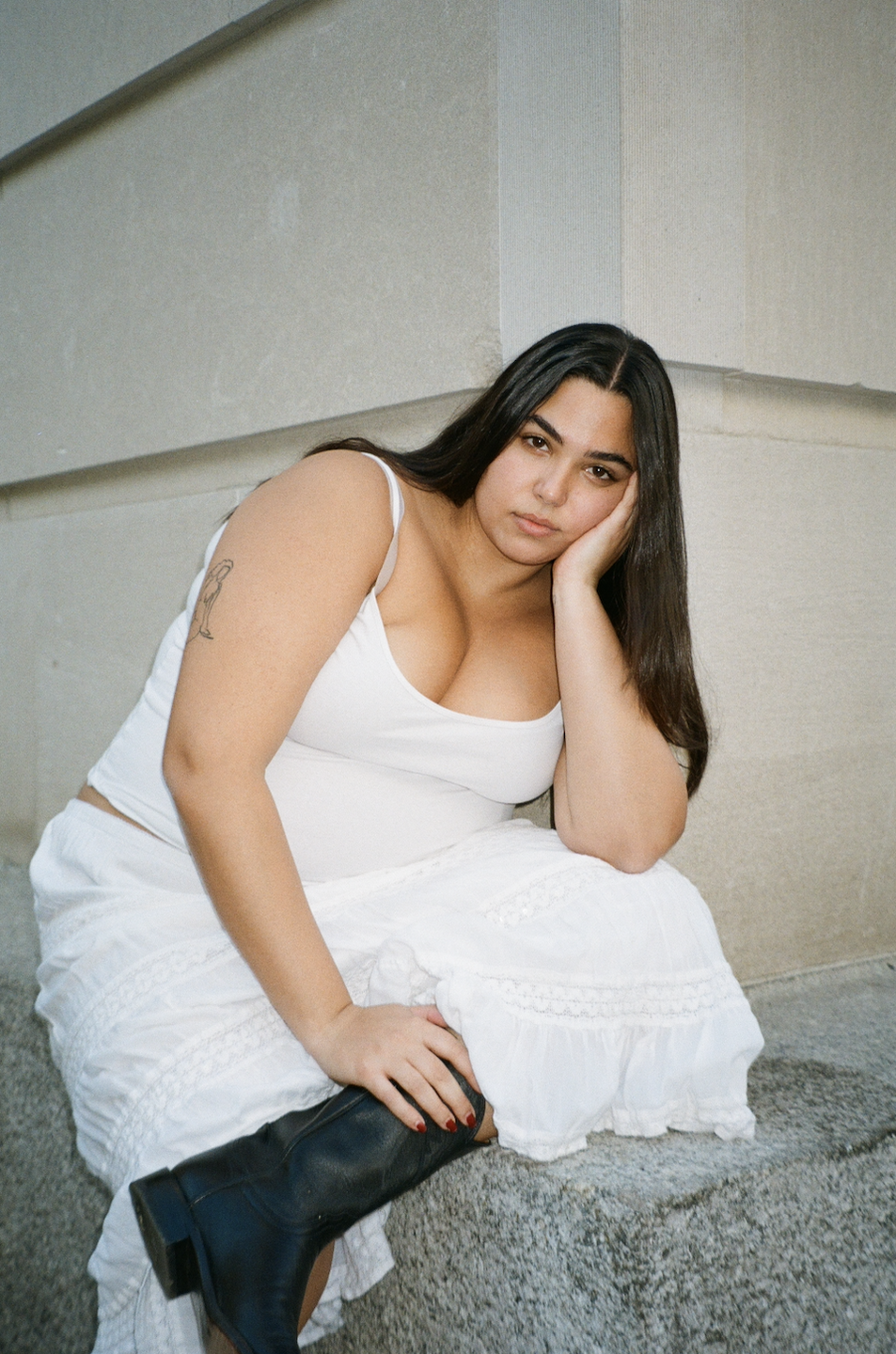 a woman sitting on a ledge