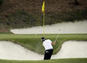 Phil Mickelson hits out of a bunker on the 12th hole during the second round of the Masters golf tournament Friday, April 11, 2014, in Augusta, Ga. (AP Photo/Charlie Riedel)