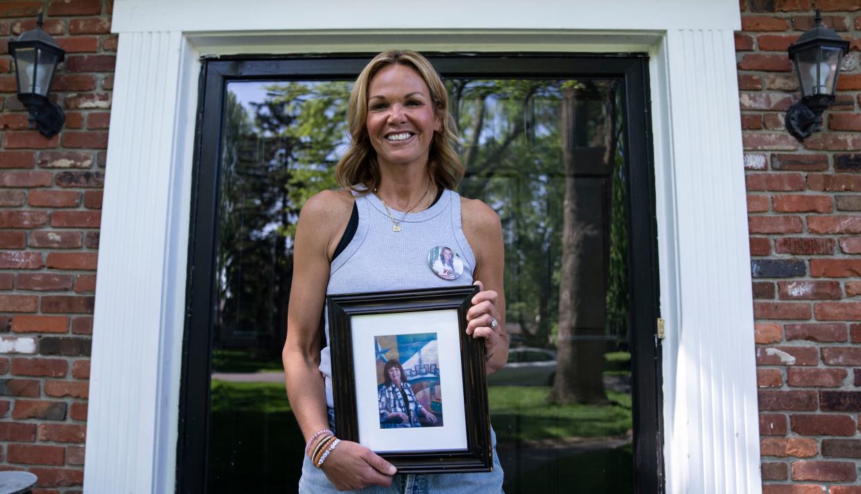 Amy Dinwiddie holds a photo of her mother, Susan Jordan on Wednesday, May 10, 2023 at at their home in Indianapolis. 