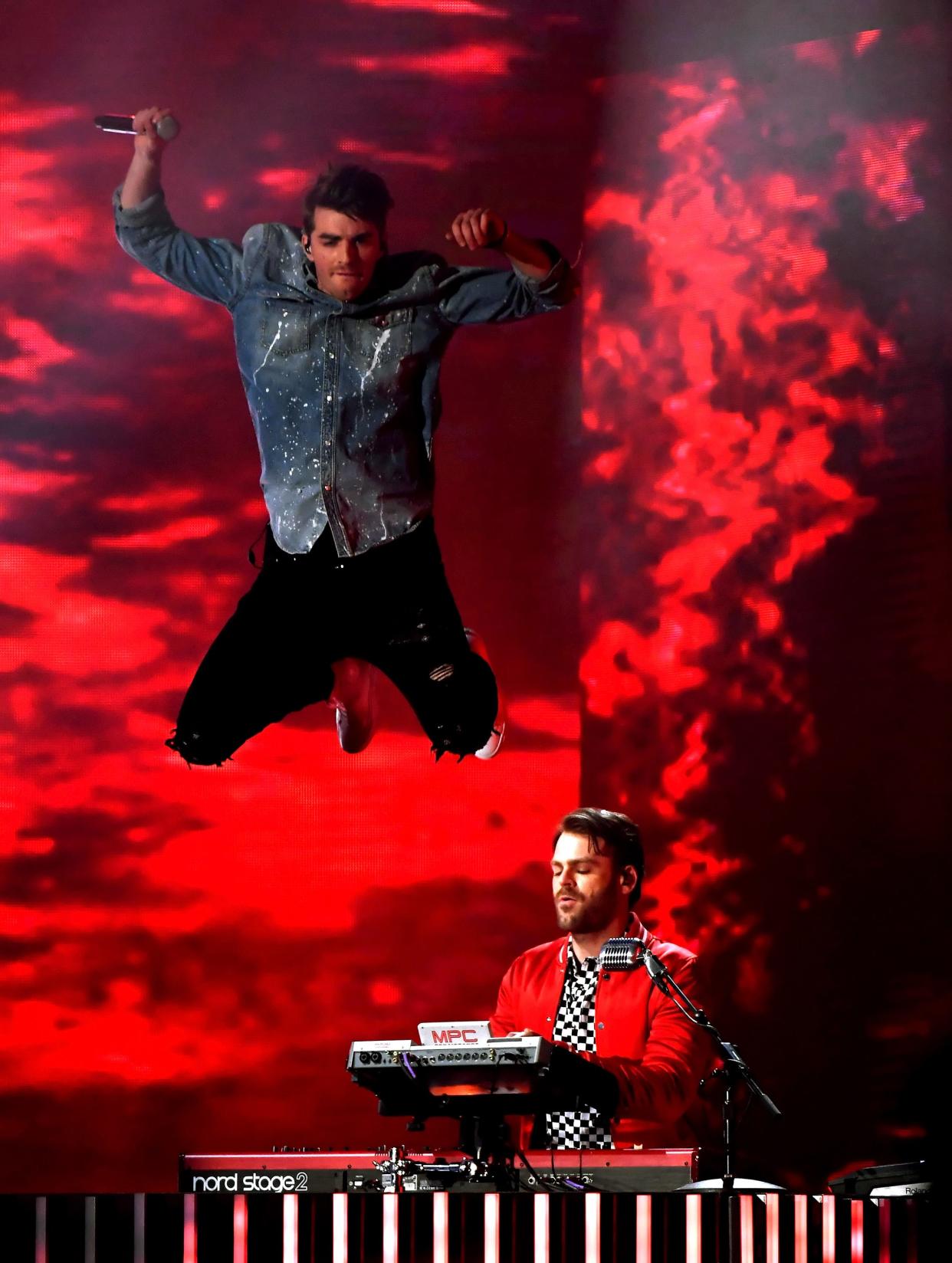Andrew Taggart, left, gets some air as band mate Alex Pall of The Chainsmokers performs during the 2017 Billboard Music Awards at T-Mobile Arena.